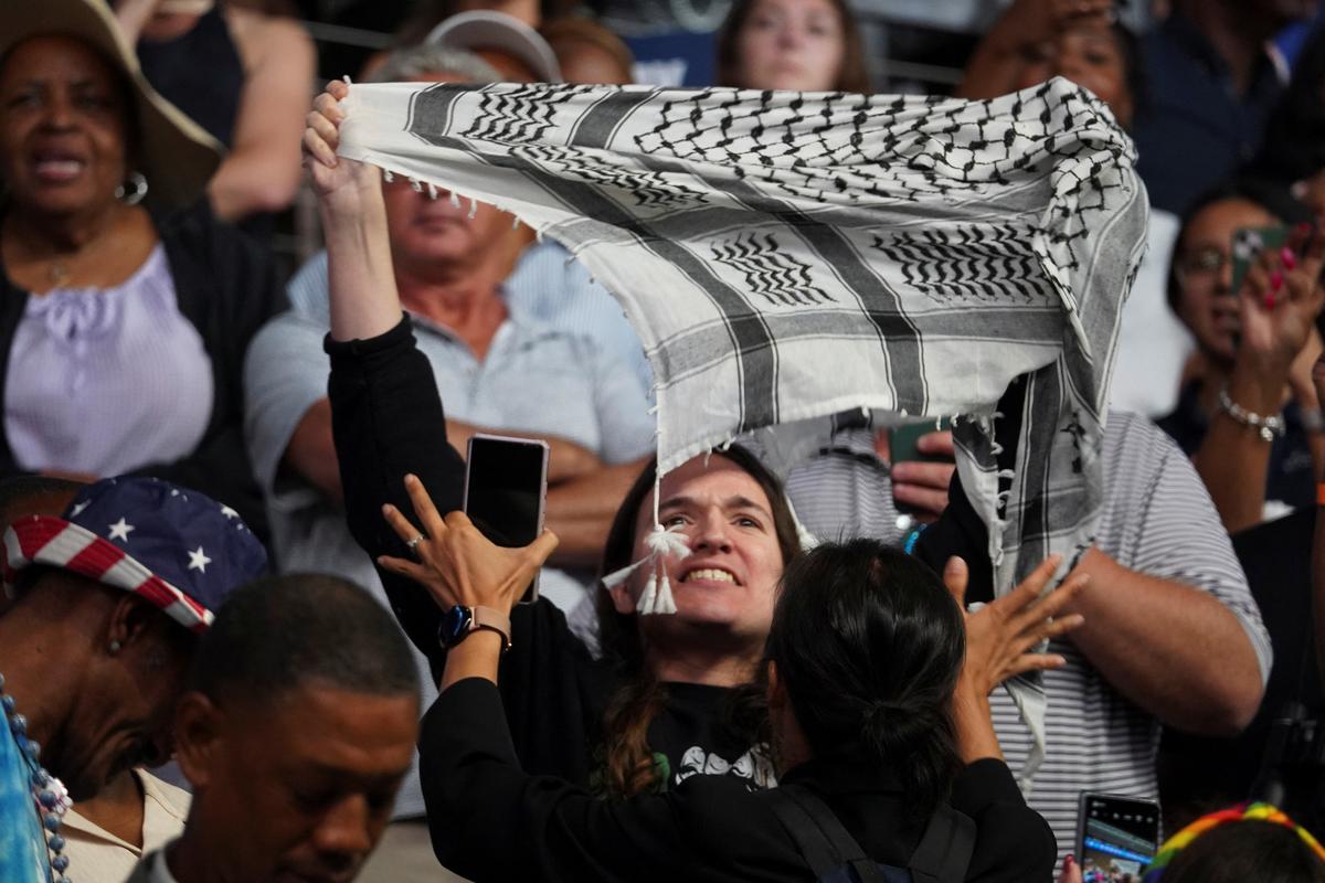 A pro-Palestinian protester holds a keffiyeh