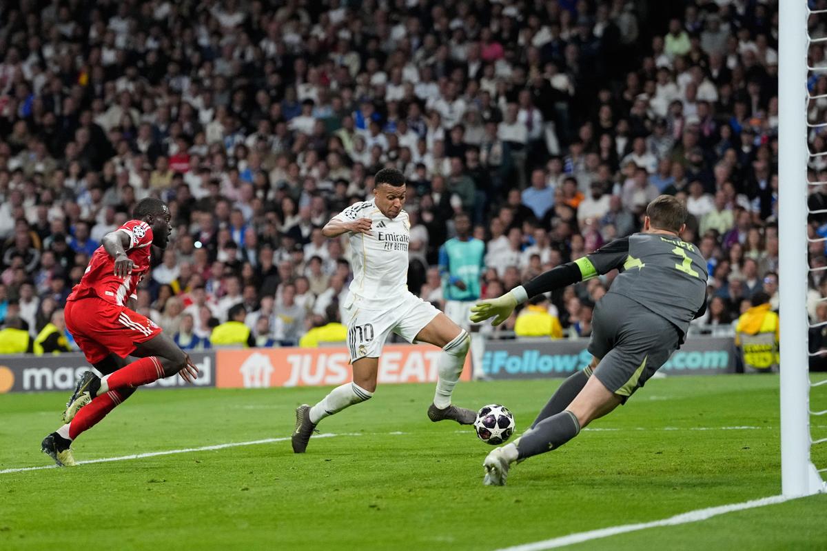 Real Madrid's Kylian Mbappe scores his side's opening goal during the Champions League quarterfinal against Bayern Munich Real Madrid's Kylian Mbappe scores his side's opening goal during the Champions League quarterfinal against Bayern Munich