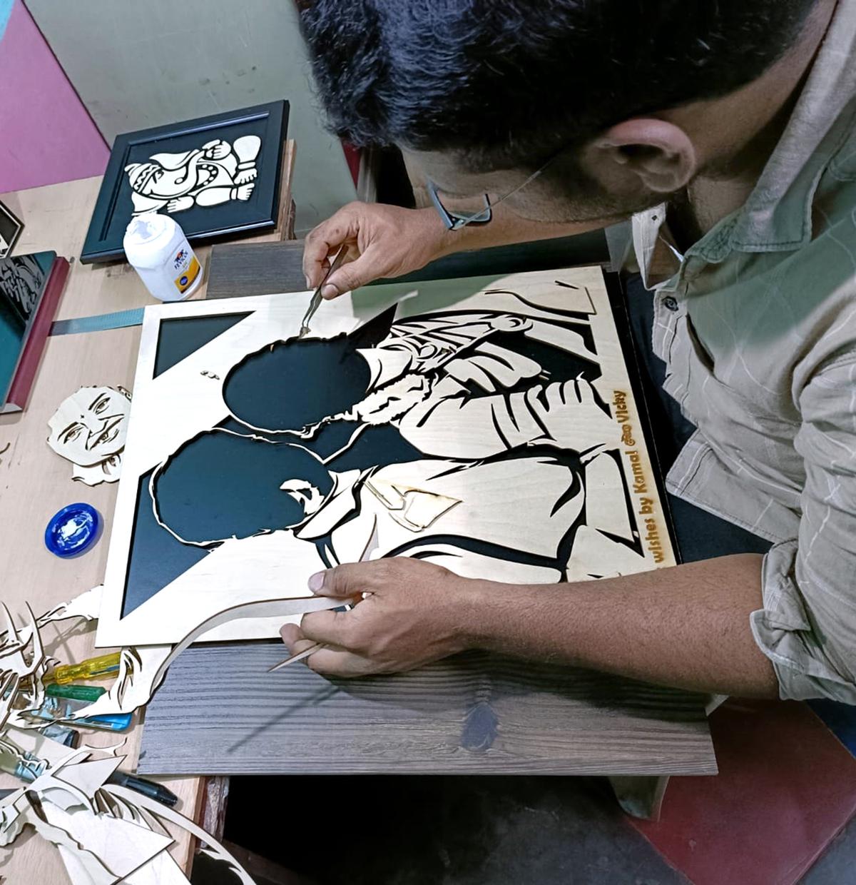 R Vignesh assembling a wooden drawing made out of vector drawing.