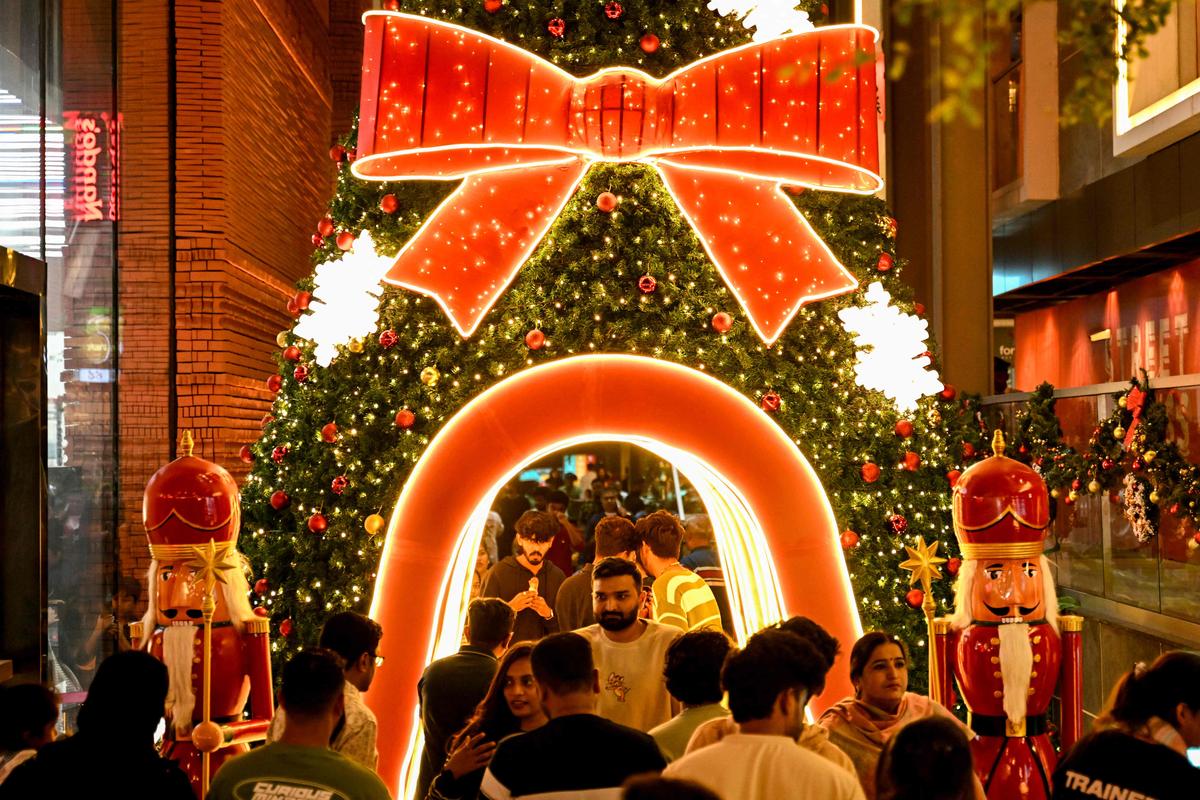 File photo of shoppers standing next to a decorated Christmas tree installed in front of a store ahead of Christmas, at Church Street.