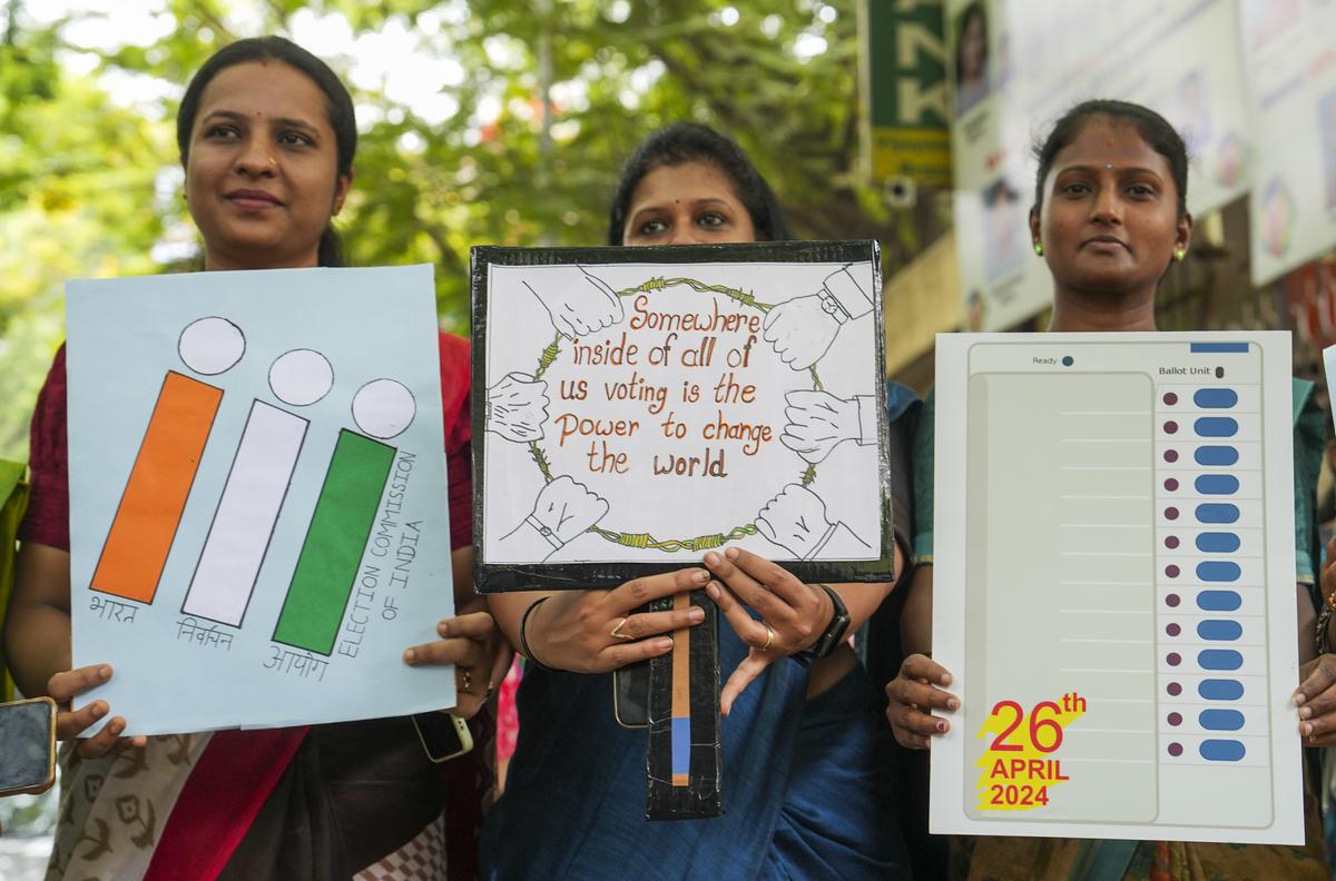 Students with placards urging people to vote for ongoing Lok Sabha polls take part in a voter awareness campaign.