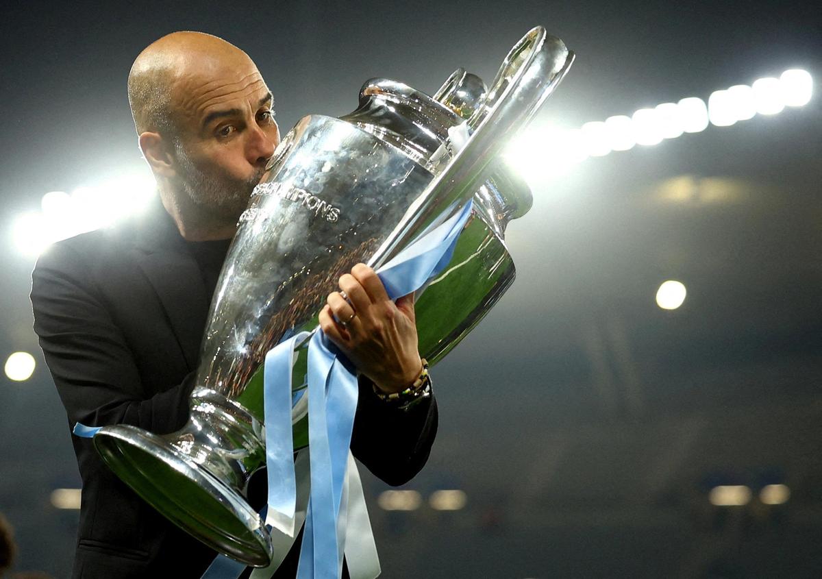 Manchester City manager Pep Guardiola celebrates with the trophy after winning the Champions League