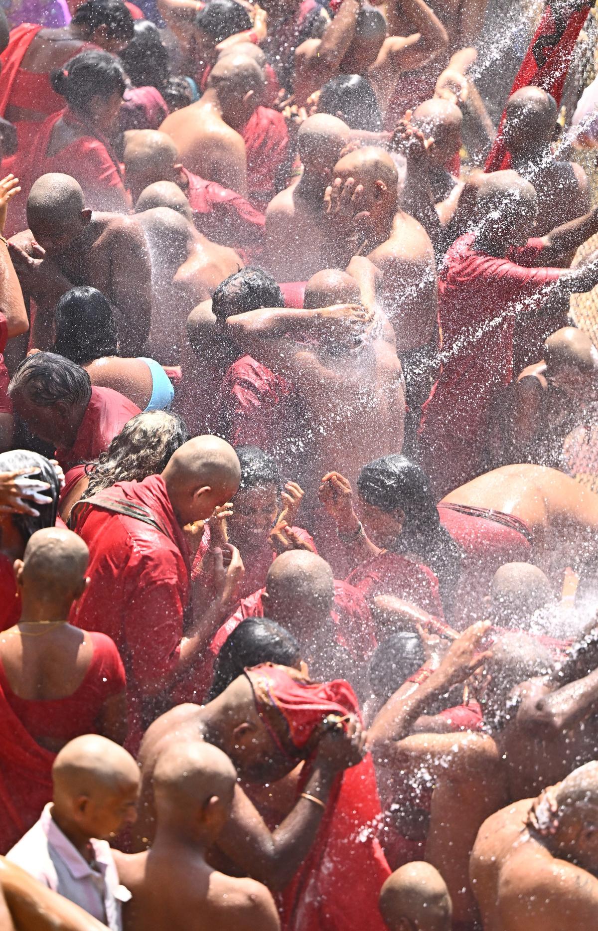 Bhavani devotees taking shower bath at Durga ghat, near Kanaka Durga temple in Vijayawada on Friday. 