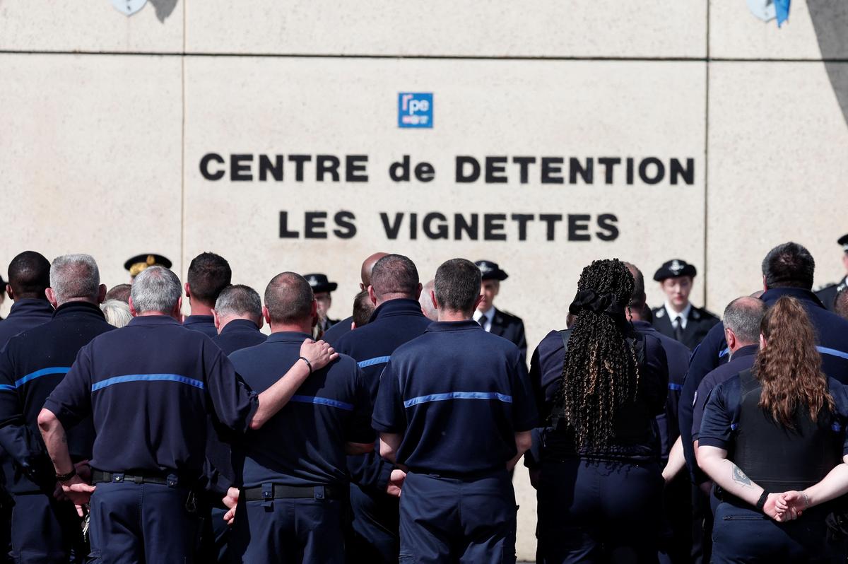 Prison staff observe a moment of silence at the Detention Center after gunmen freed a drug dealer, killing two prison guards and severely wounding three others, in Val De Reuil, France, May 15, 2024.  