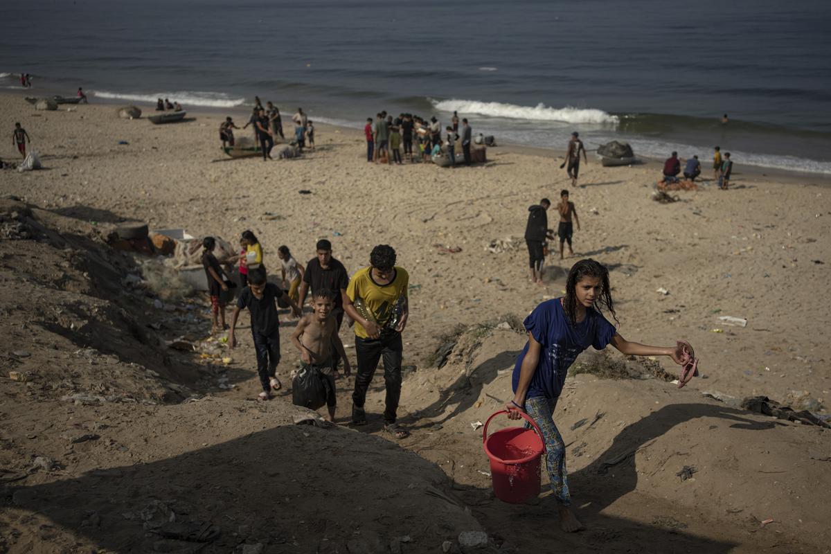 Palestinians carry seawater home from the beach in Deir al Balah, Gaza Strip, Thursday, Nov. 2, 2023.  