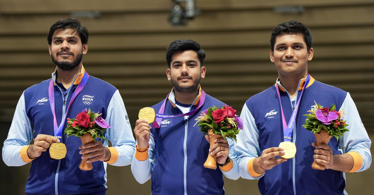 Indian shooters Rudrankksh Patil (right), Aishwary Pratap Singh Tomar (centre) and Divyansh Singh Panwar pose for photos with their gold medals during the presentation ceremony of Men’s 10m Air Rifle team event at the 19th Asian Games, in Hangzhou, China, on  September 25, 2023. 