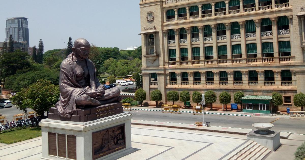 A bronze statue of a meditating Mahatma Gandhi next to Vidhana Soudha in Bengaluru.