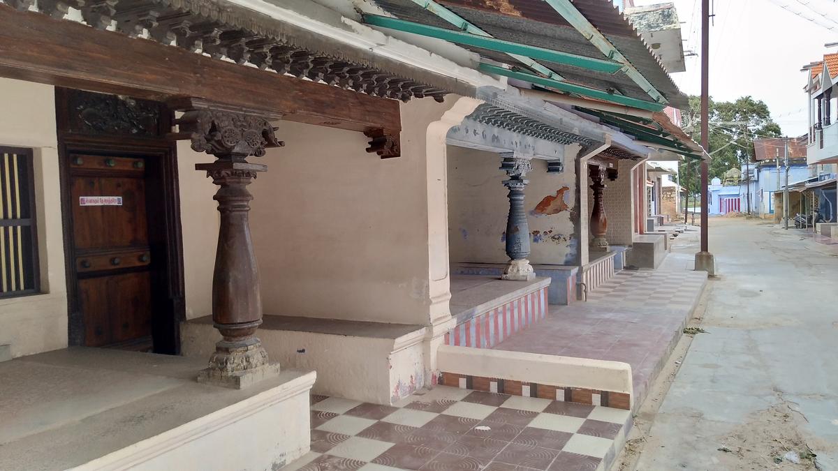 Row houses with verandahs and red oxide floors.