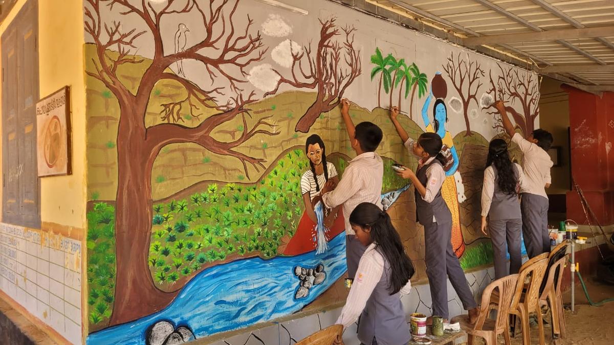 Students of P Bhaskaran Memorial Higher Secondary School at Kodungallur painting the walls with the imagery inspired by the poet-lyricist's verses. 