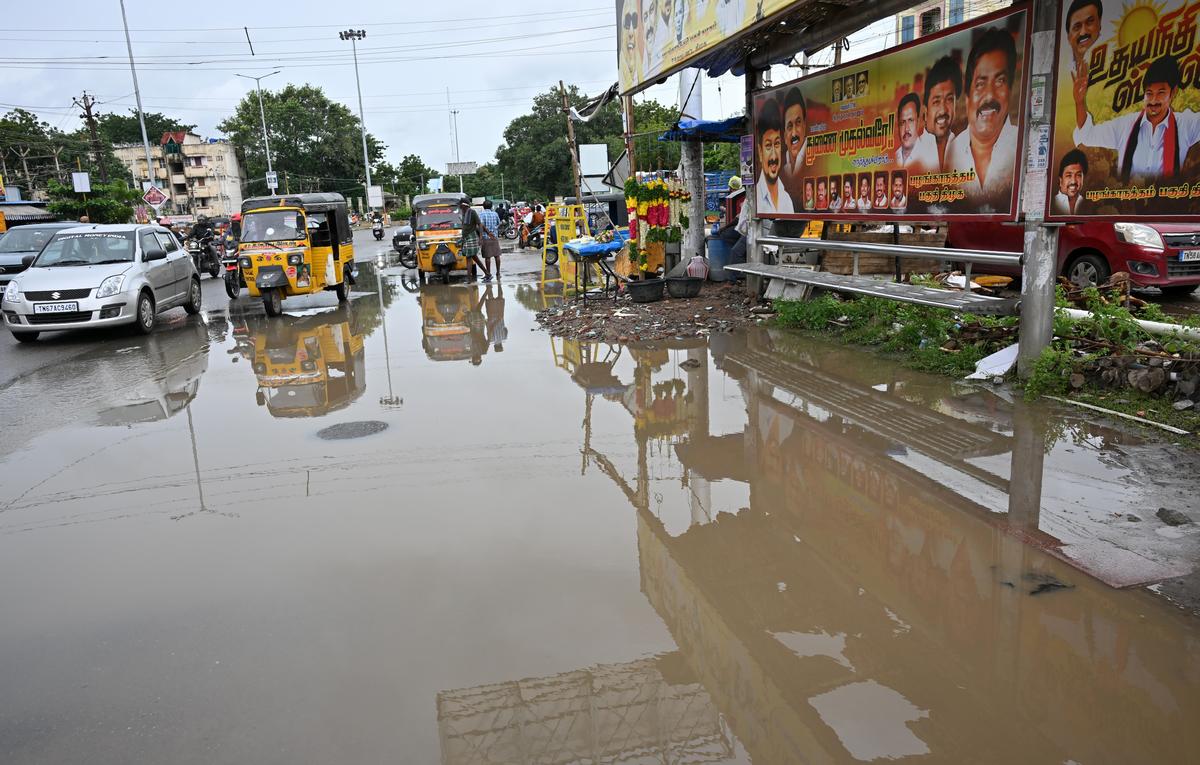 Rain water logged at Jayam theatre bus stop at Palanganatham in Madurai on Monday. 