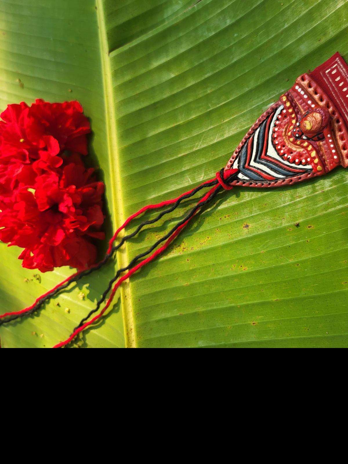 Handmade pendant and chain made by Arish John Andrews, which has been inspired by the ritualistic art of Theyyam.  