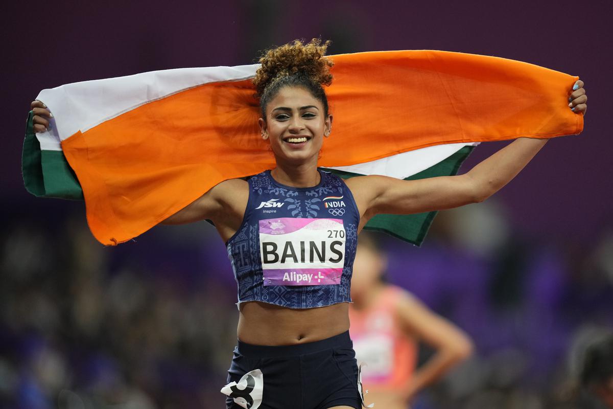 Harmilan Bains celebrates after finishing second in the women’s 1500-meter final at the 19th Asian Games in Hangzhou, on October 1, 2023.