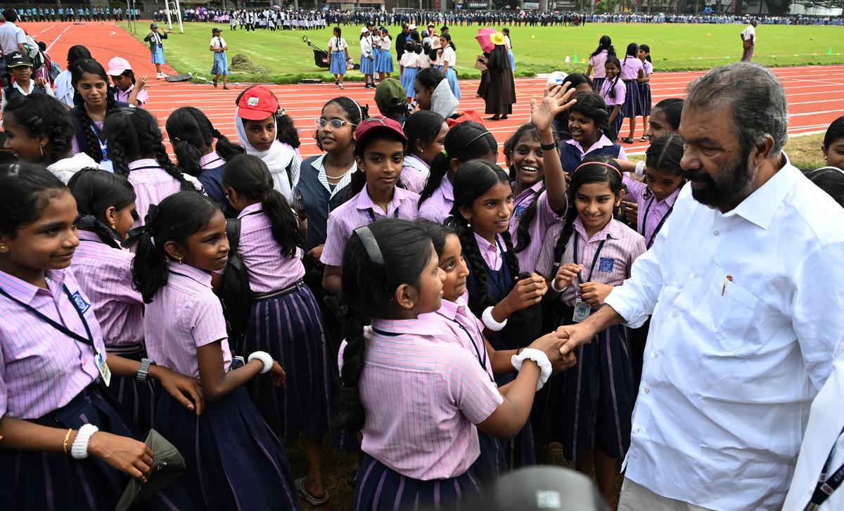 Education Minister V. Sivankutty interacts with students during his visit to the ground to evaluate preparations for the meet.
