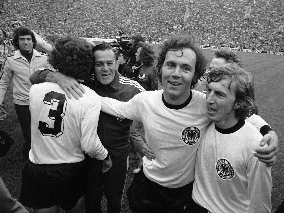 File picture of West German national team captain Franz Beckenbauer, second from right, embracing his teammate, forward Juergen Grabowski, while walking around the Olympic stadium, after West Germany beat the Netherlands 2-1 in the Football World Cup Final game at the Olympic Stadium in Munich, Germany, on July 7, 1974. 