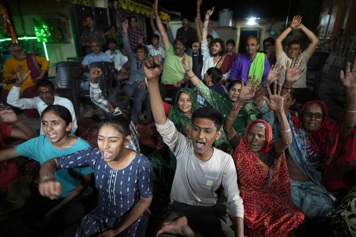 Villagers cheer as they celebrate the safe return of NASA astronaut Suni Williams from the International Space Station (ISS), at a temple in her ancestral village Jhulasan in Mehsana district of Gujarat on March 19, 2025. 