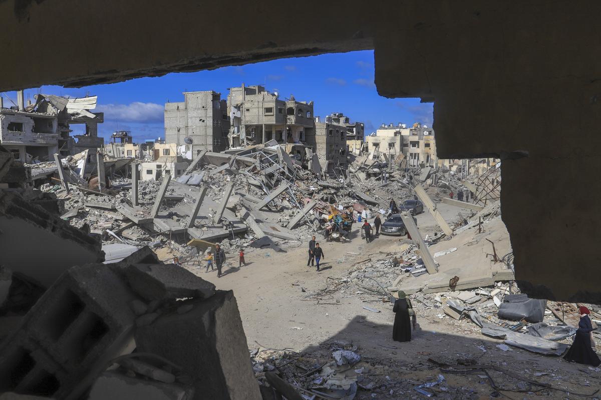 File picture of Palestinians walking through the rubble caused by the Israeli air and ground offensive in Rafah, southern Gaza Strip File picture of Palestinians walking through the rubble caused by the Israeli air and ground offensive in Rafah, southern Gaza Strip