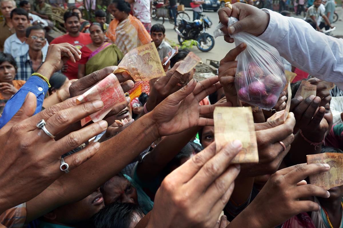 People scramble to buy onions that costed ₹100 per kg during the inflation of 2013. People scramble to buy onions that costed ₹100 per kg during the inflation of 2013.