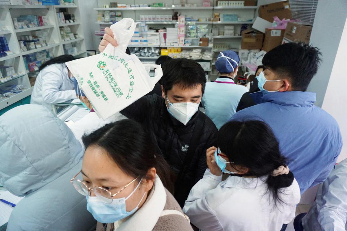 People line up to buy antigen test kits for the coronavirus disease (COVID-19), at a pharmacy in Hangzhou, Zhejiang province, China.