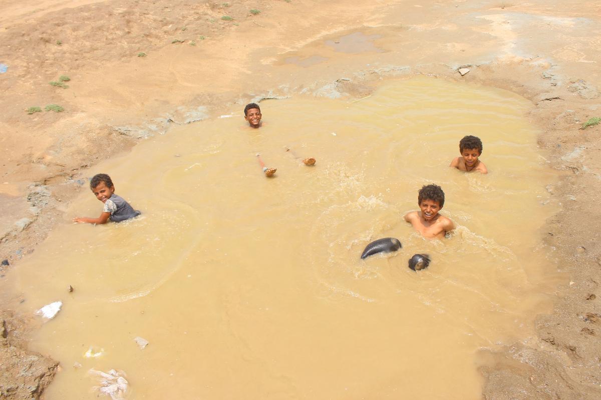 A large puddle near a camp for people displaced by conflict in Yemen’s Hajjah province on August 27. Clinics in western Yemen have been inundated with suspected cholera patients after heavy rains and flooding.