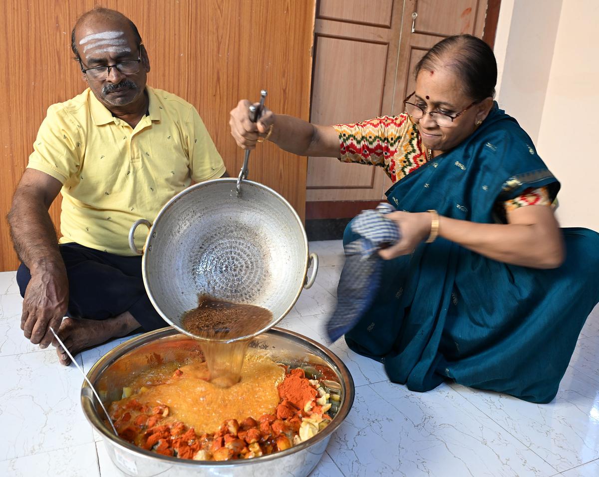 V. Vaidyanathan his wife Revathi as she tempers mango pickle with hot gingelly oil at their home-based unit in Srirangam. The couple run the Vembu Iyer pickle brand from home.