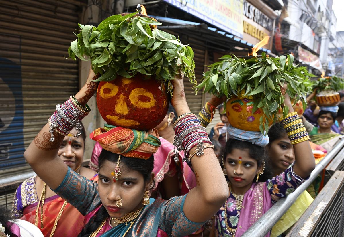 Devotees carrying ‘Bonam’ at the annual Ujjaini Mahankali Bonalu Jatra, also called ‘Lashkar Bonalu’ in Secunderabad on Sunday. Devotees carrying ‘Bonam’ at the annual Ujjaini Mahankali Bonalu Jatra, also called ‘Lashkar Bonalu’ in Secunderabad on Sunday.
