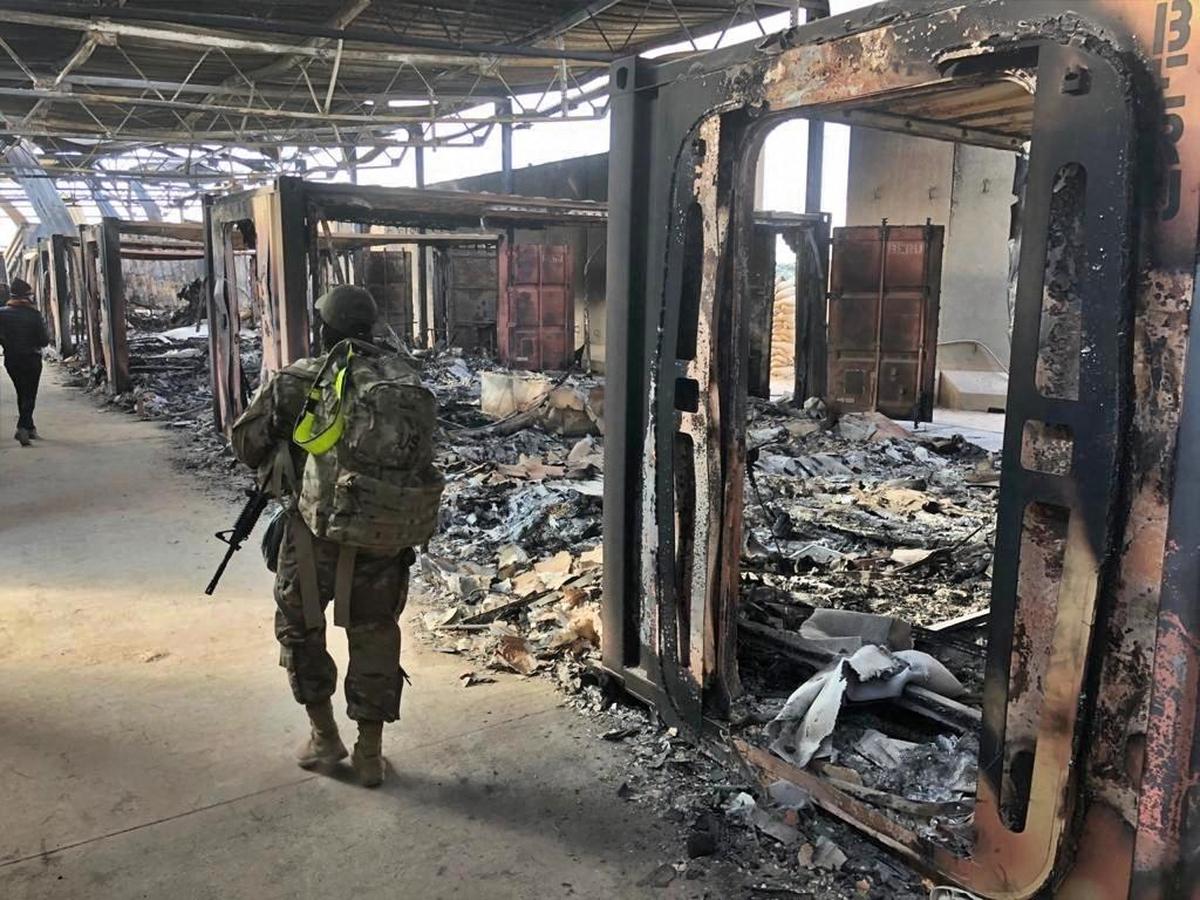 ESCALATION: U.S. soldiers walk past a site of Iranian bombing at the Ain al-Asad air base, in Anbar, Iraq, on January 13, 2020. The airbase was struck by a barrage of Iranian missiles, in retaliation for a U.S. drone strike that killed Gen. Qassem Soleimani.