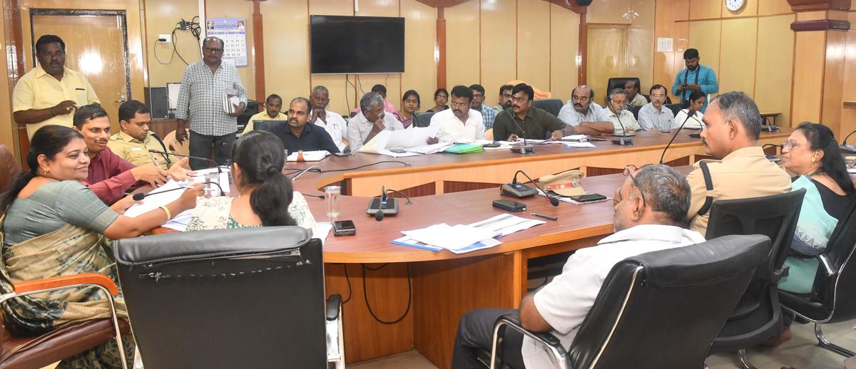 Social Welfare Minister P. Geetha Jee,van along with officials participating in the preparation of monsoon review meeting in Thoothukudi Collectorate on Tuesday. 