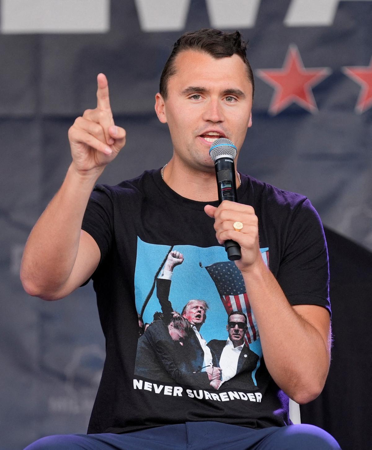 Charlie Kirk speaks while wearing a shirt with a picture taken during Republican presidential nominee and former U.S. President Donald Trump’s attempted assassination on Day 3 of the Republican National Convention (RNC), at the Fiserv Forum in Milwaukee, Wisconsin, U.S., July 17, 2024