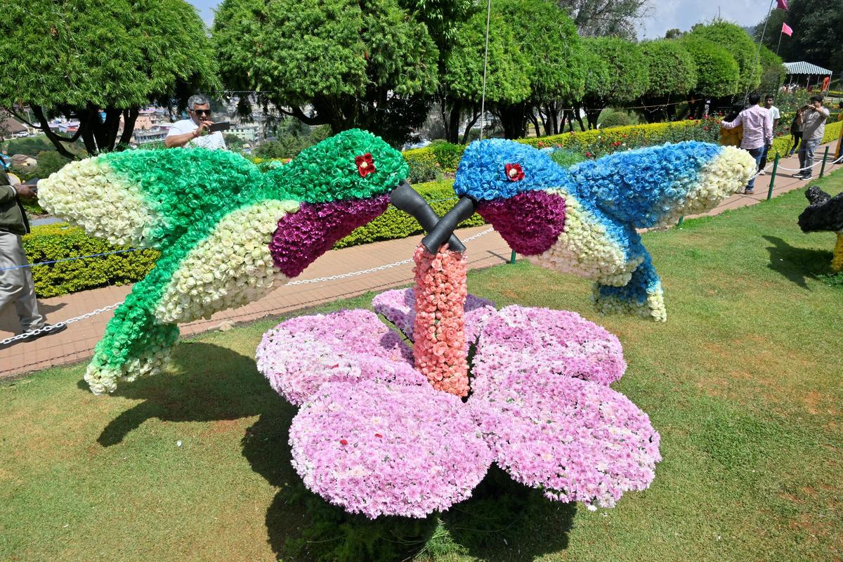 Different varieties of floral bird ornaments are displayed at the Rose Show in Udhagamandalam.