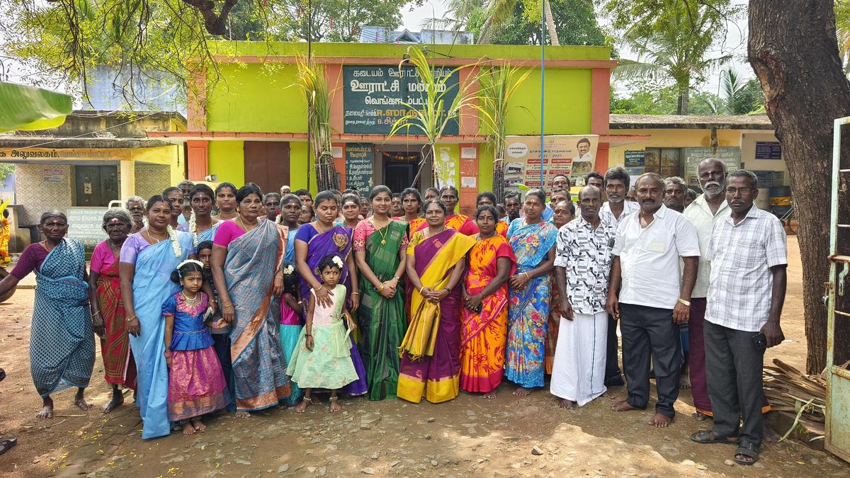 R. Sharukala, the panchayat president of Venkatampatti panchayat in Tenkasi district, along with staff members and residents of the village, during a Pongal event