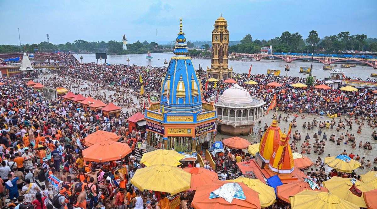 ‘Kanwariyas’ or Lord Shiva devotees gather at Har ki Pauri to collect holy water of the Ganga river during ‘Kanwar Yatra’ in the holy month of ‘Shravan’ on the occasion of ‘Sawan Shivratri’, in Haridwar, July 15, 2023. 