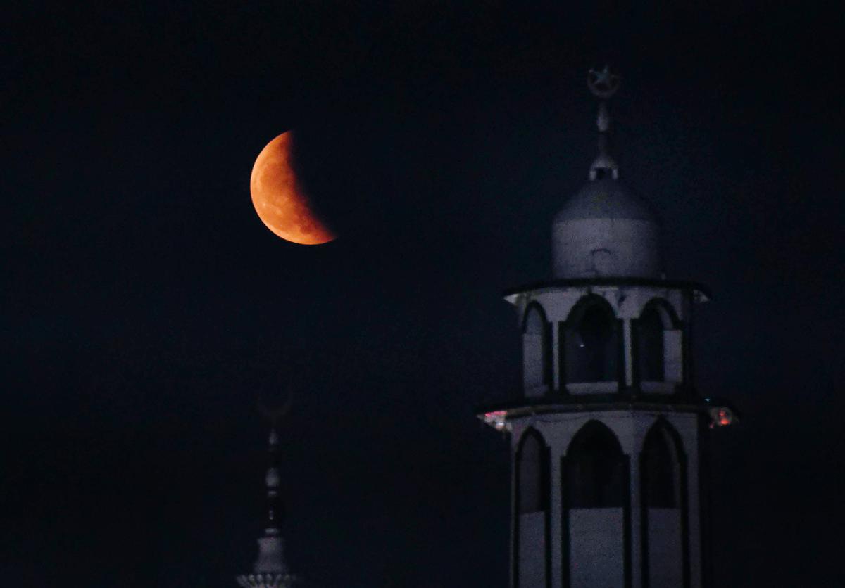 Moon partially covered by the earth's shadow during lunar eclipse in Patna.