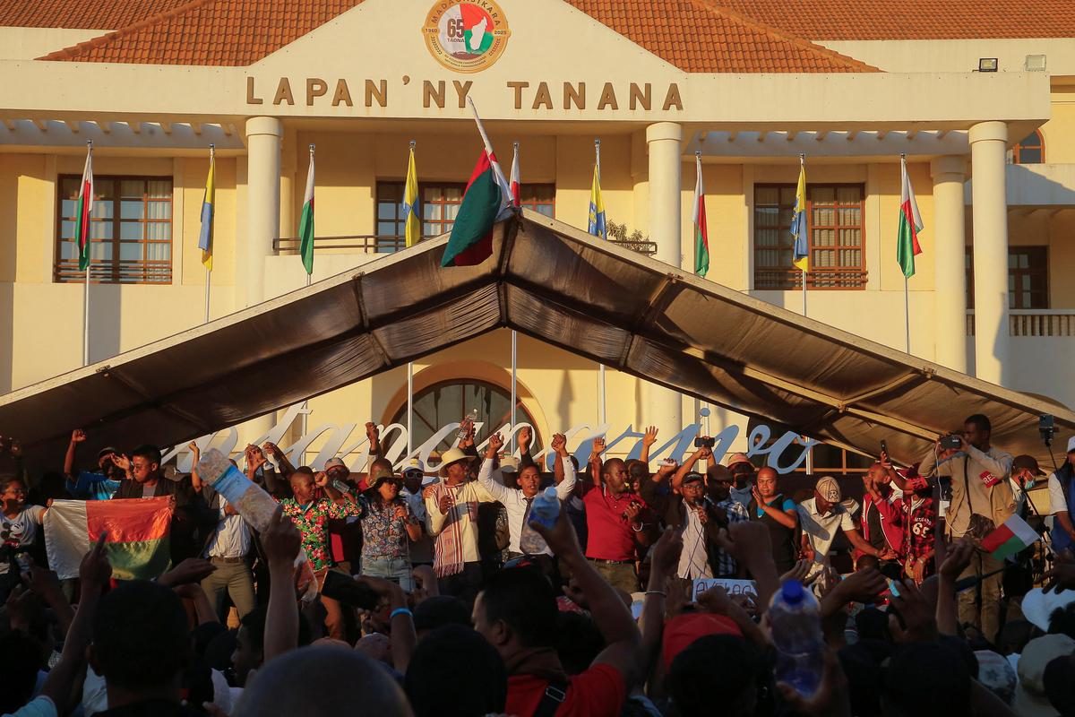 Protesters gesture outside the town hall on Independence Avenue during a nationwide youth-led protest over frequent power outages and water shortages, in Antananarivo, Madagascar.