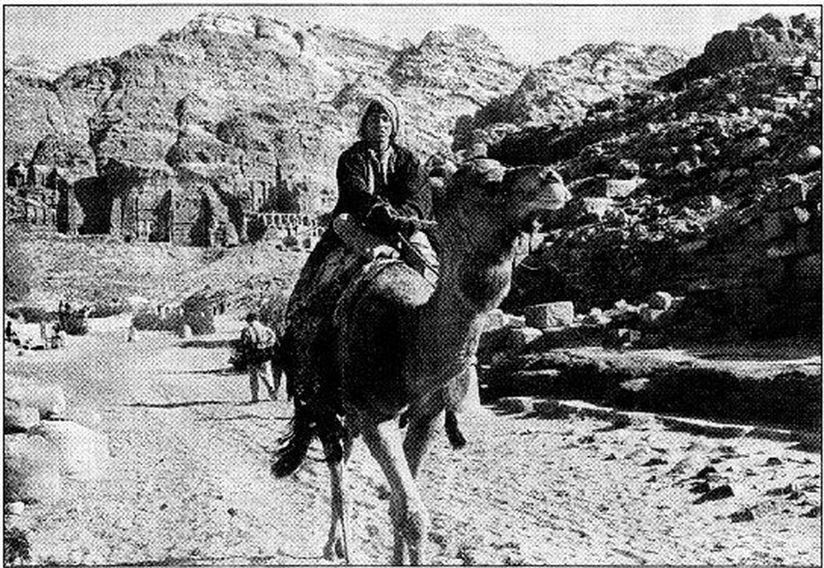 A Jordanian Bedouin rides a camel in the ancient Nabatean city of Petra