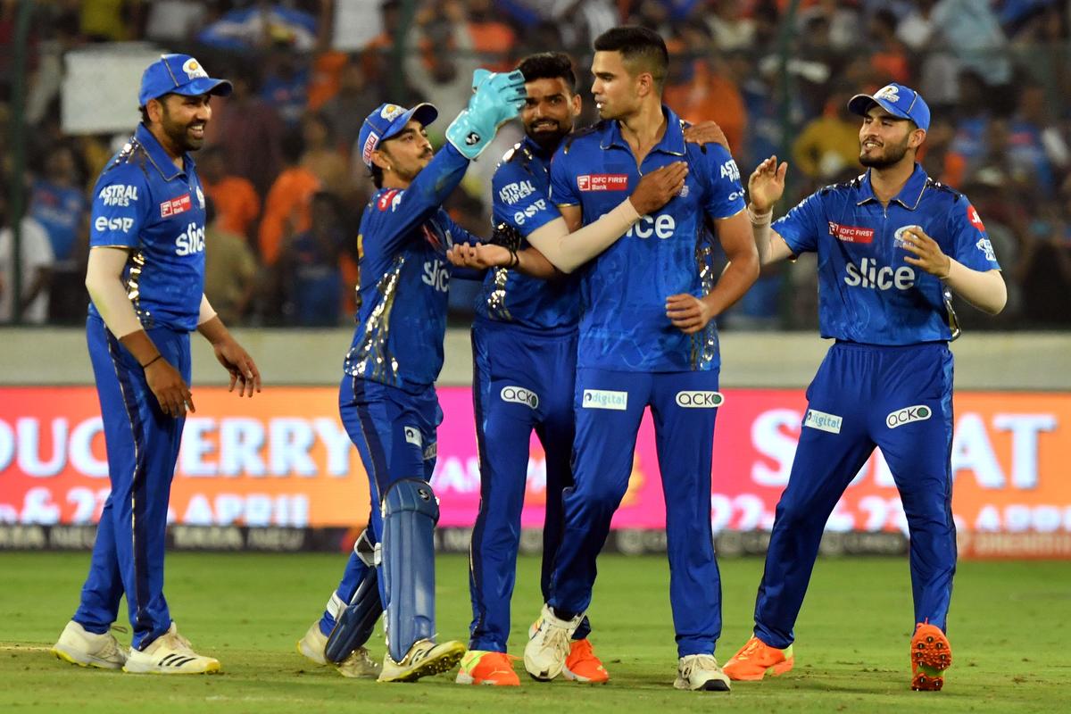 Mumbai Indians’ Jason Behrendorff celebrates a wicket with teammates in a match against Sunrisers Hyderabad during the Indian Premier League (IPL) Twenty20 cricket match between Sunrisers Hyderabad and Mumbai Indians at the Rajiv Gandhi International Cricket Stadium in Uppal in Hyderabad on April 18, 2023. 