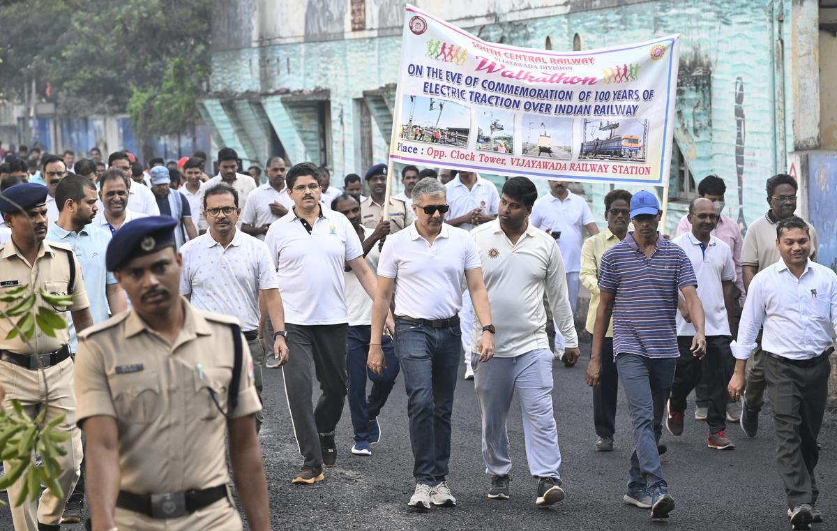 Vijayawada Divisional Railway Manager Narendra A. Patil and other officers participating in the walkathon to mark the 100-years electrification in Indian Railways, at Vijayawada railway station on Monday.