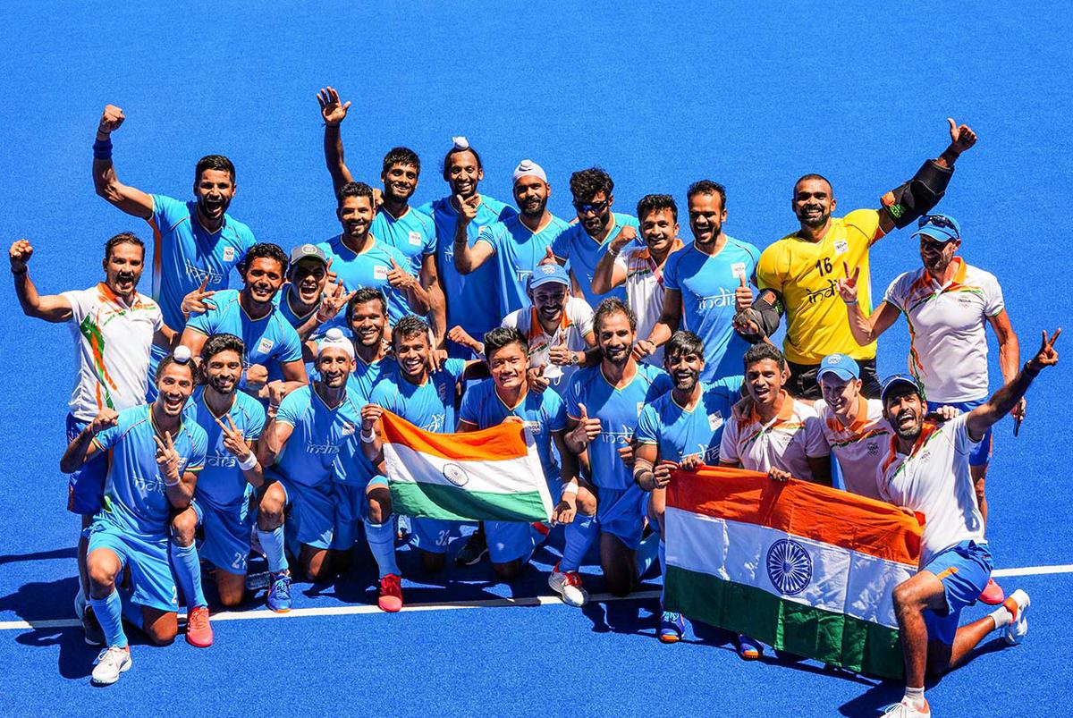 Indian players pose for photographs as they celebrate their victory over Germany in the men’s field hockey bronze medal match, at the 2020 Summer Olympics, in Tokyo, on Aug. 5, 2021. 