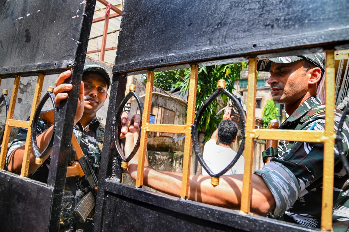 CRPF personnel stand guard during a search at the residence of  TMC MLA Madan Mitra by CBI in connection with the alleged irregularities in recruitments made by the civic bodies in the State, in Kolkata.