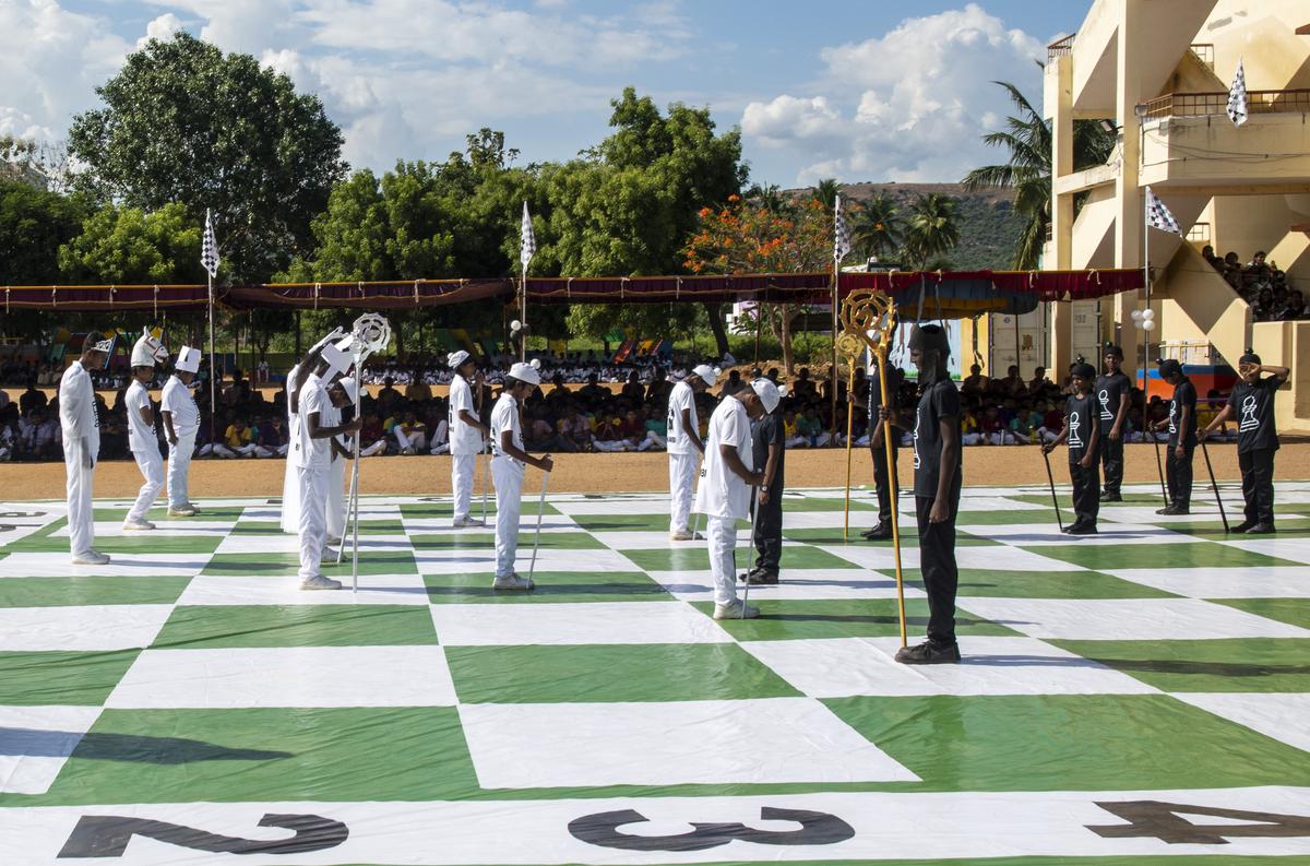 Students dressed up as chess pieces and move across a life sized board during the International Chess Day celebration at Keren School in Madurai