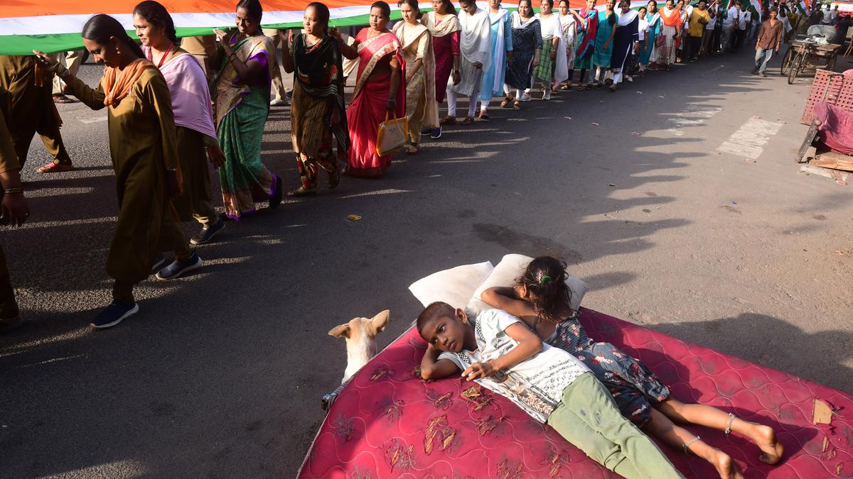 Postal staff take out rally with 100-foot-long national flag