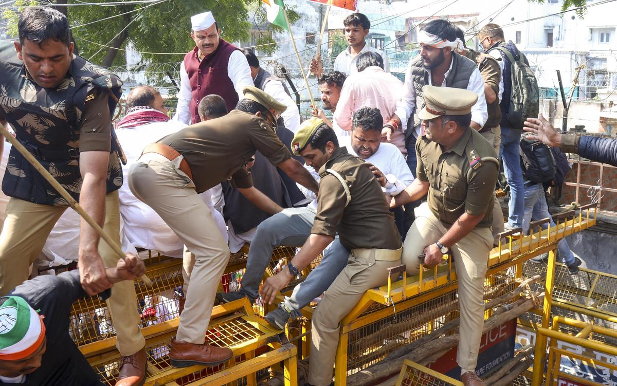 Security personnel detain Congress workers during a protest as part of the MGNREGA Bachao Sangram, in Lucknow