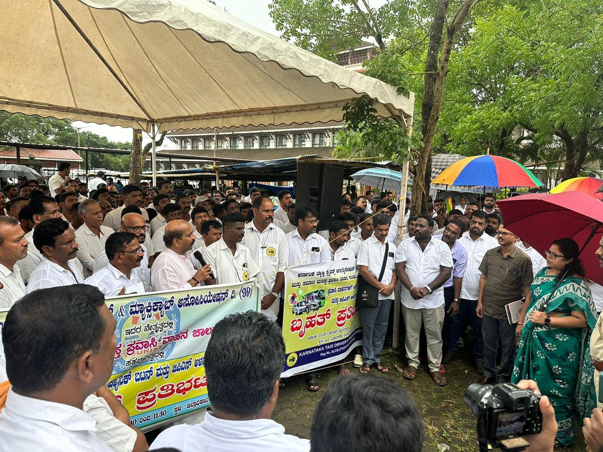 Members of Udupi District Taximen and Maxicab Association staging a protest in Udupi on Tuesday. 