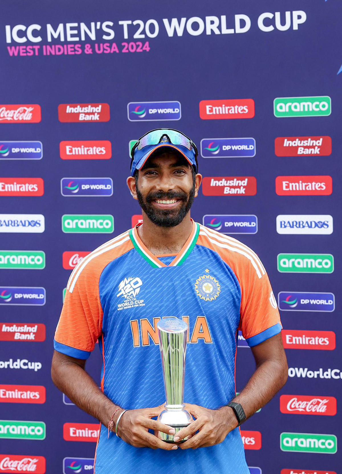 asprit Bumrah poses for a picture with the trophy after Team India wins the final match against South Africa, at Kensington Oval in Barbados.