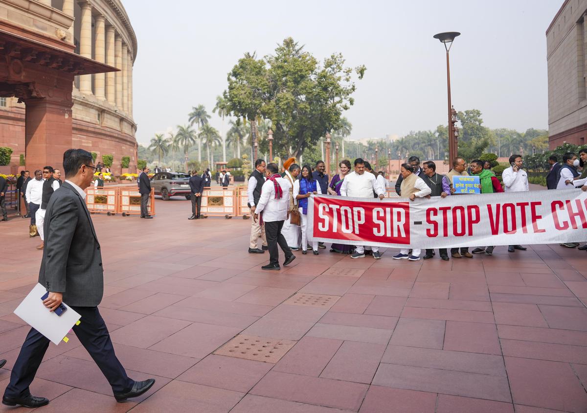 Parliamentary Affairs Minister Kiren Rijiju, left, arrives as Opposition leaders protest against Special Intensive Revision (SIR) at Parliament complex during Winter session, in New Delhi, on December 2, 2025. Parliamentary Affairs Minister Kiren Rijiju, left, arrives as Opposition leaders protest against Special Intensive Revision (SIR) at Parliament complex during Winter session, in New Delhi, on December 2, 2025.