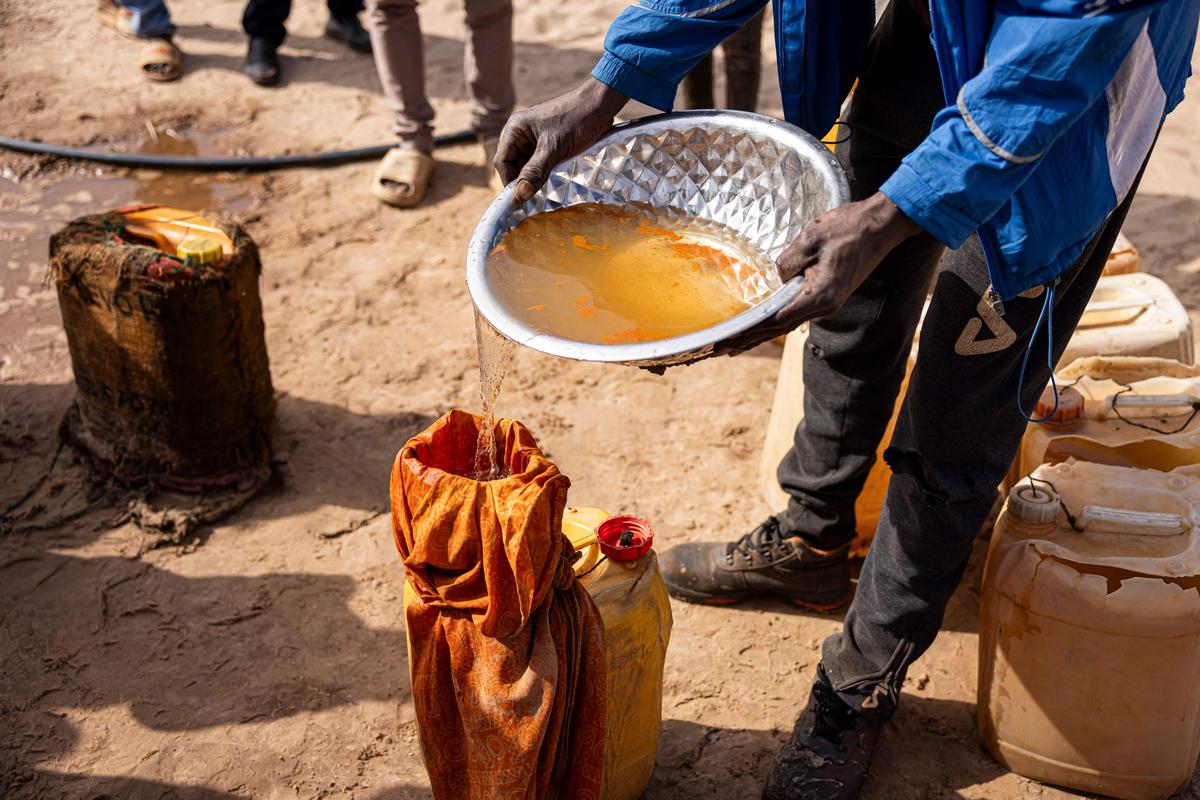 A resident demonstrates how people filter water in the village of Foth, Senega.