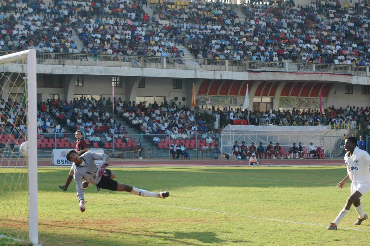 Mohun Bagan's goalkeeper Subrata Paul beaten by Dempo Sports Club's Cristiano Junior (not in picture) as Ronty Soleye Martins (right) looks on during the final match of the 26th Federation Cup football tournament at the Sree Kanteerava Stadium in Bengaluru on December 5, 2004.