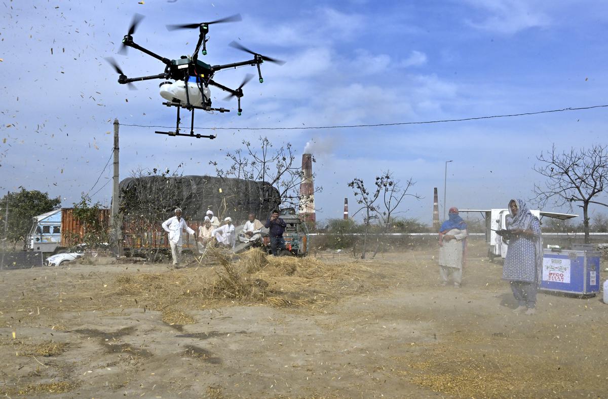 Ram Raji flying a drone that sprays fertilizer on crops. Ram Raji flying a drone that sprays fertilizer on crops.