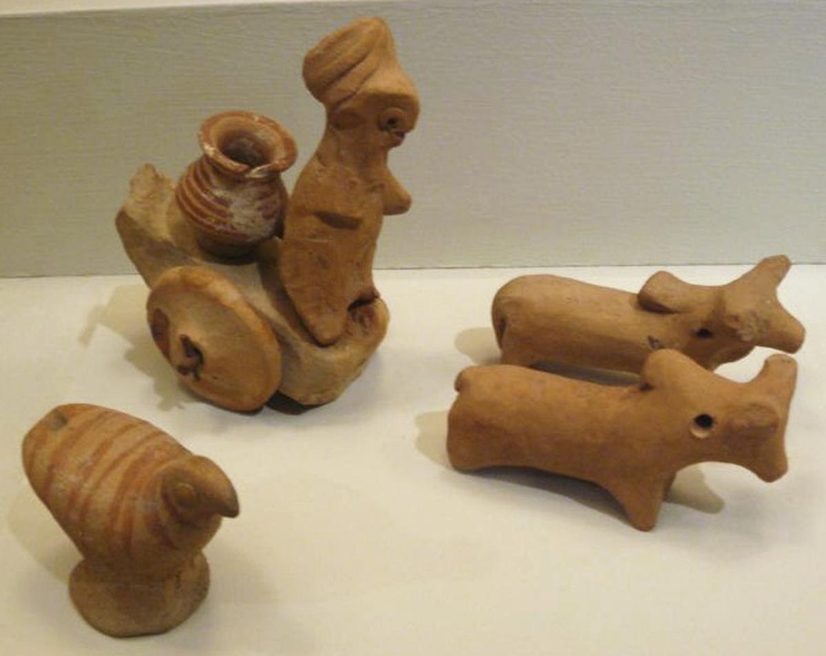 Miniature votive images or toys from Harappa, c. 2500 BCE, clay figurines of zebu oxen, a cart, and a chicken.