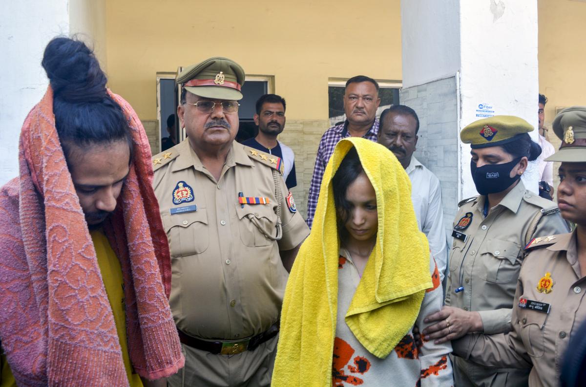 Police take away Merchant Navy officer Saurabh Rajput’s wife Muskan and her lover Sahil Shukla after they were arrested in connection with his murder, in Meerut, on March 19, 2025. 