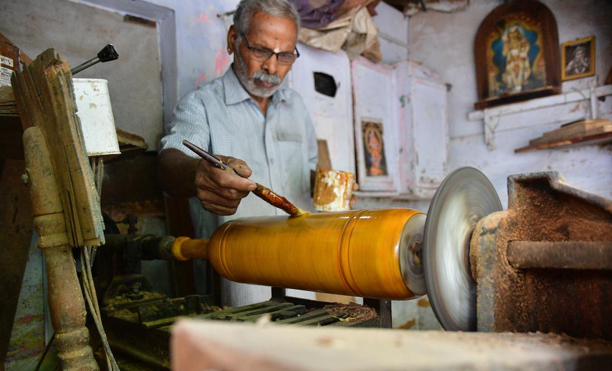 A Arumugam makes the equipment with a wood turning lathe